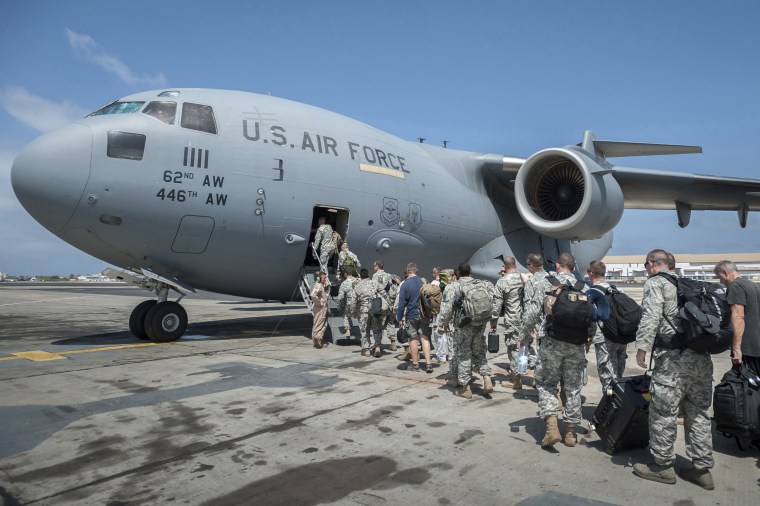 A group of 30 U.S. military personnel, bound for Liberia to help in global efforts to fight the Ebola virus outbreak, board a plane in Senegal