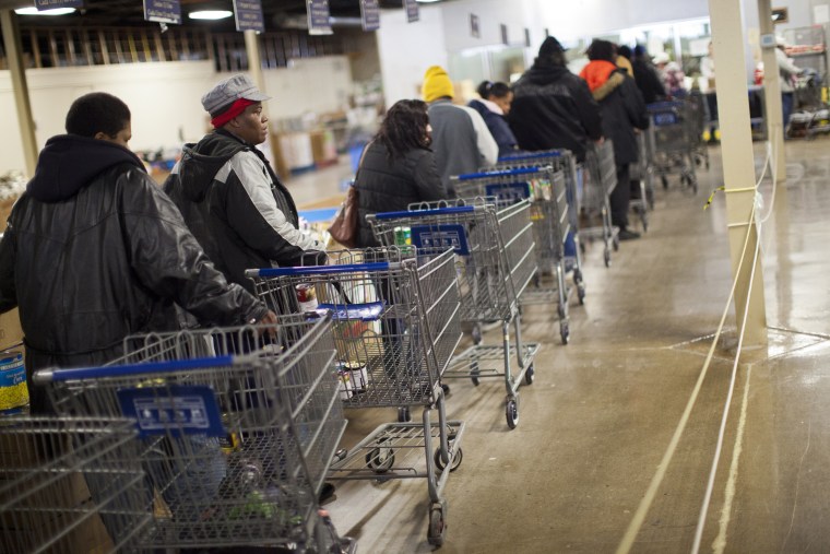 Clients wait in line to shop for food at St. Vincent de Paul food pantry in Indianapolis