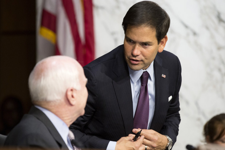 Senator Marco Rubio (R-FL) speaks with Senator John McCain (R-AZ) on Capitol Hill in Washington on Sept. 17, 2014.