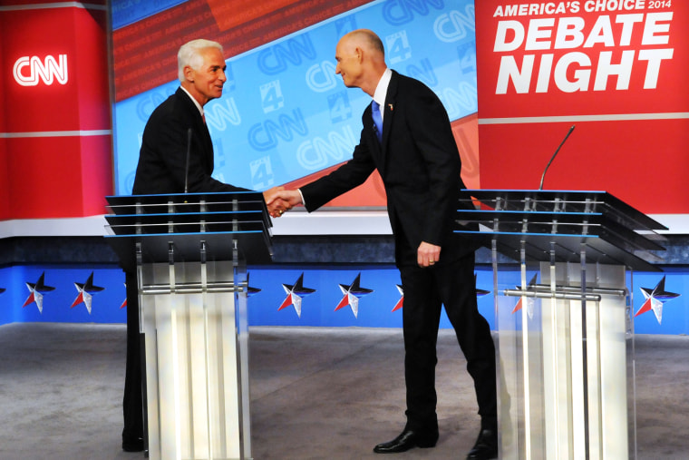 Democratic candidate Charlie Crist, left, and Republican Gov. Rick Scott shake hands before their live television debate on Oct. 21, 2014 in Jacksonville, Fla.
