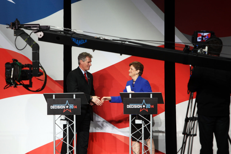 U.S. Sen. Jeanne Shaheen, right, shakes hands with Republican challenger Scott Brown on Oct. 21, 2014 in Concord, N.H.