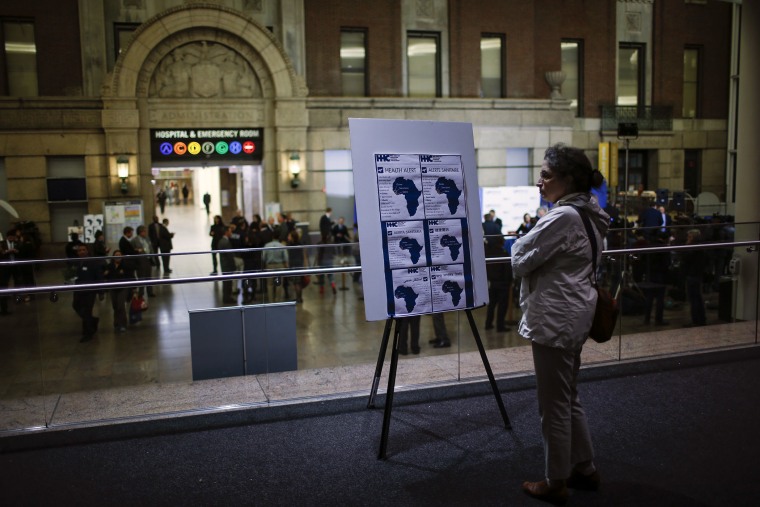A woman reads alert on Ebola inside the Bellevue Hospital where Dr. Craig Spencer is being treated for Ebola symptoms in New York on Oct. 23, 2014.