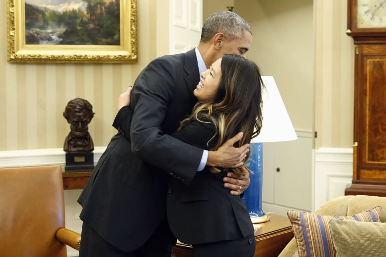 U.S. President Barack Obama hugs Dallas nurse Nina Pham at the Oval Office in Washington, on Oct. 24, 2014. Pham, who contracted the disease while treating a man who later died of Ebola in a Dallas hospital, had been undergoing treatment at the National I