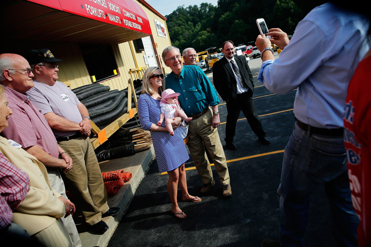 Senate Minority Leader Mitch McConnell (R-KY) poses for a photo while campaigning at a Rental Pro store during a two-day bus tour of eastern Kentucky on Aug. 7, 2014 in Hazard, Ky. (Photo by Win McNamee/Getty)