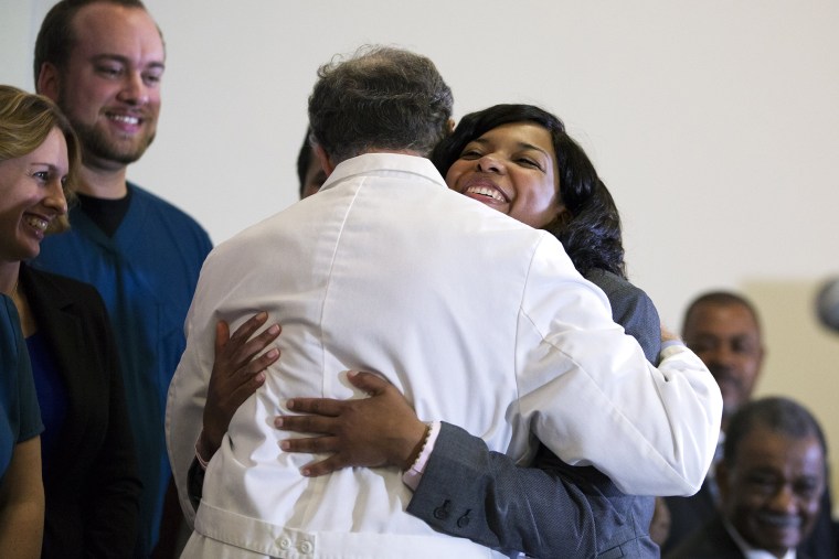 Amber Vinson, embraces Emory University Hospital epidemiologist Dr. Bruce Ribner, as she leaves a press conference after being discharged from the hospital, on Oct. 28, 2014, in Atlanta.