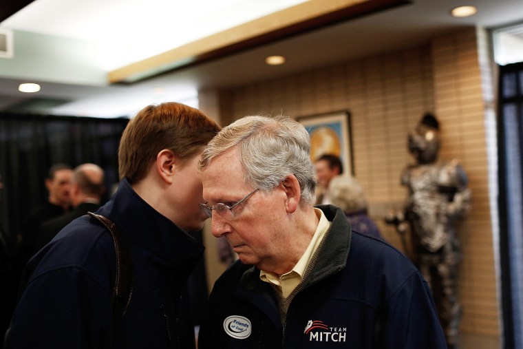 Senate Minority Leader Mitch McConnell (R-KY) (R) confers with an aide after speaking at a campaign rally Oct. 22, 2014 in Grayson, Ky.