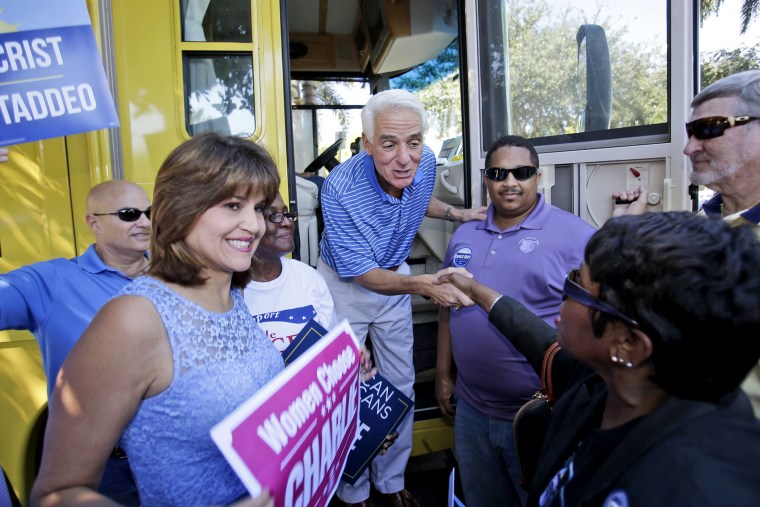 Florida Democratic gubernatorial candidate Charlie Crist, center, is greeted by supporters as he and his running mate Annette Taddeo-Goldstein, left, make a brief campaign stop on Oct. 25, 2014 in Fort Lauderdale, Fla.