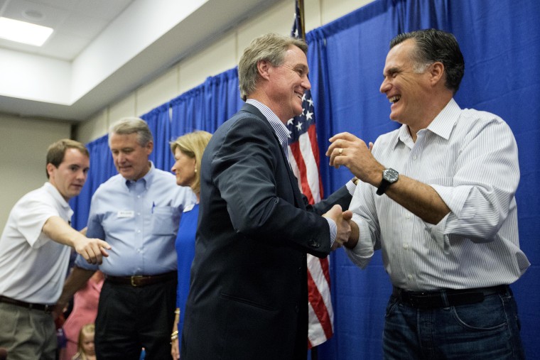 Former Republican presidential nominee Mitt Romney, right, embraces Georgia Republican U.S. Senate candidate David Perdue during a campaign event. on Oct. 29, 2014, in Augusta, Ga. (David Goldman/AP)