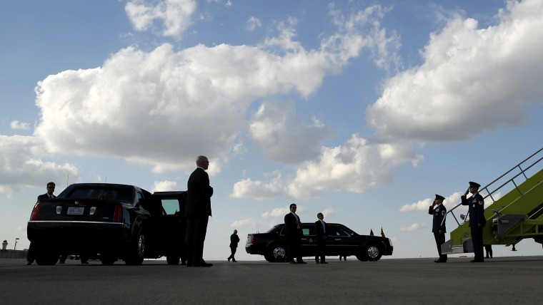Secret Service Agents stand by the limousines and Air Force One crew salute as U.S. President Barack Obama arrives in Denver July 8, 2014. (Photo by Kevin Lamarque/Reuters)