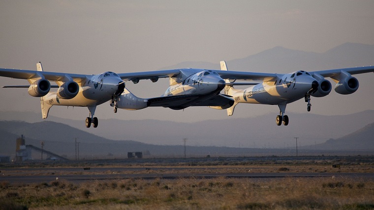 This photo released by Virgin Galactic shows the first captive-carry flight of VSS Enterprise or SpaceShipTwo over Mojave, Calif. on March 22, 2010. (Mark Greenberg/Virgin Galactic/AP)