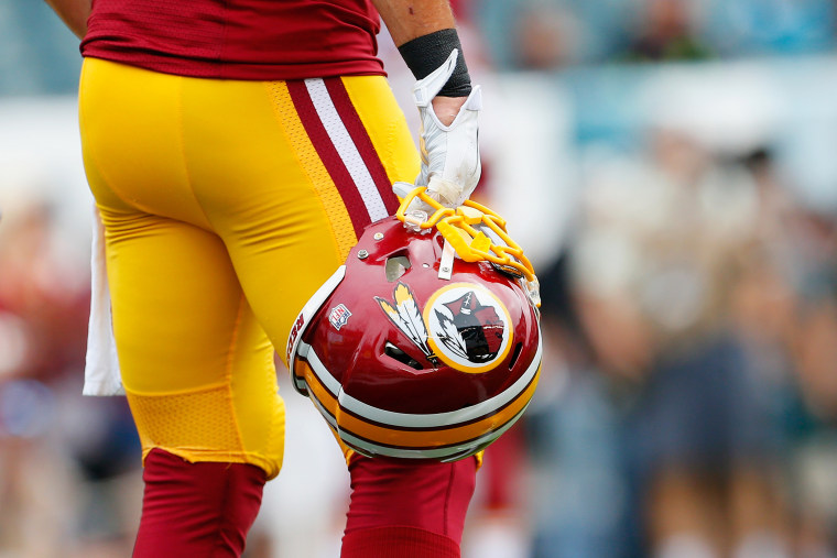 A Washington Redskins helmet is carried by a player on Sept. 21, 2014 in Philadelphia, Pa. (Photo by Rich Schultz/Getty)