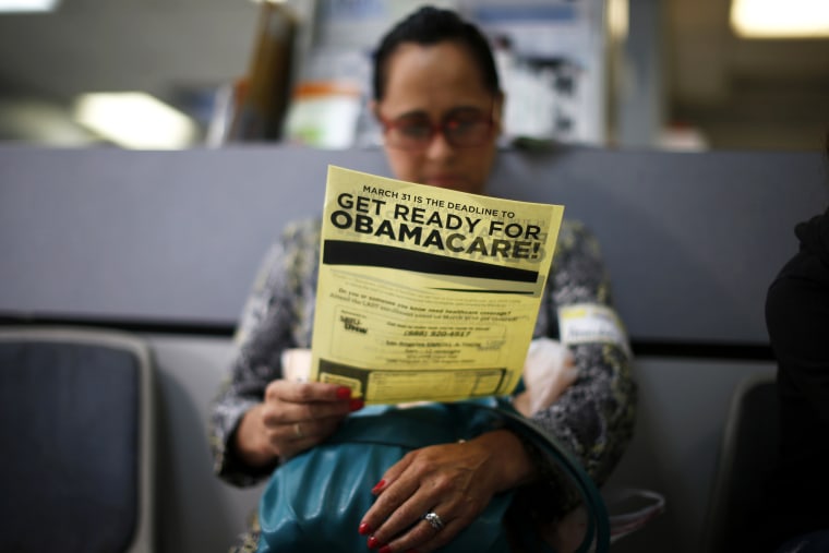 Arminda Murillo, 54, reads a leaflet at a health insurance enrollment event in Cudahy, Calif., March 27, 2014. (Photo by Lucy Nicholson/Reuters)