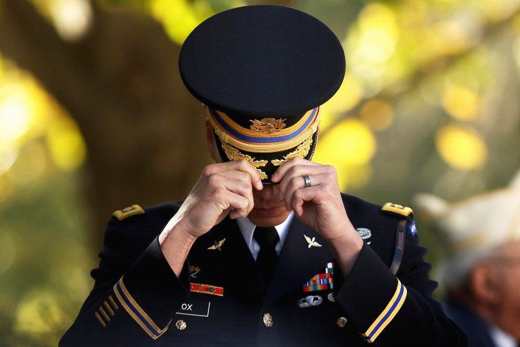An officer from the 3rd U.S. Infantry Regiment adjusts his cover at The Tomb of the Unknown Soldier during Veterans Day observations at Arlington National Cemetery on Nov. 11, 2014 in Arlington, Va. (Photo by Chip Somodevilla/Getty)