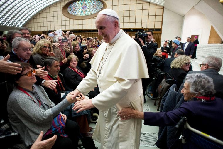 Pope Francis (C) greets people during his audience with members of the Italian Catholic Doctors' Association at the Vatican on Nov. 15, 2014.