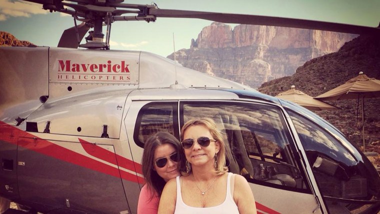 In this Oct. 21, 2014, file photo provided by TheBrittanyFund.org, Brittany Maynard, left, hugs her mother Debbie Ziegler next to a helicopter at the Grand Canyon National Park in Arizona. (TheBrittanyFund.org/AP)
