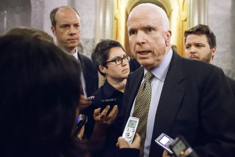 Sen. John McCain, R-Ariz., speaks to reporters as he leaves the Senate chamber after a roll call vote, at the Capitol in Washington, Nov. 12, 2014.