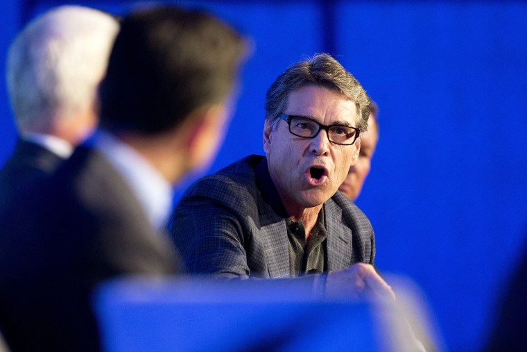 Texas Gov. Rick Perry talks about the costs of illegal immigration in his state during a press conference at the Republican governors conference in Boca Raton, Fla., Nov. 19, 2014. (Photo by J Pat Carter/AP)