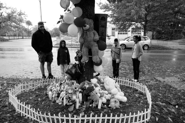 Artist Cbabi Bayoc and his children visit the Vonderrit Myers memorial on the 4100 block of St. Louis' Shaw district. Bayoc lives and works only a few blocks away from the scene of the October 8th shooting.