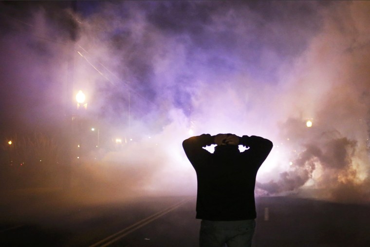 A protester stands with his hands on his head as a cloud of tear gas approaches after a grand jury returned no indictment in the shooting of Michael Brown in Ferguson, Mo. on Nov. 24, 2014. (Photo by Adrees Latif/Reuters)
