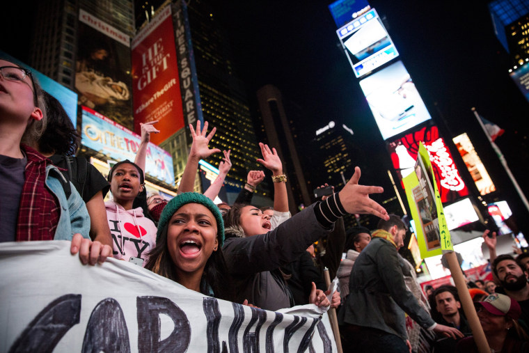People protest in Times Square over the Ferguson grand jury decision to not indict officer Darren Wilson in the Michael Brown case Nov. 25, 2014 in New York, N.Y. (Photo by Andrew Burton/Getty)