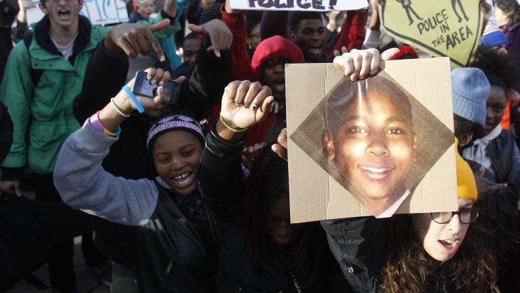 Protesters carry a photo of Tamir Rice as they march during a rally at Public Square in Cleveland, Ohio, Nov. 24, 2014.