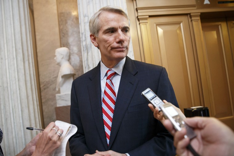 Sen. Rob Portman, R-Ohio, center, speaks with reporters in Washington, D.C., May 12, 2014. (Photo by AP)