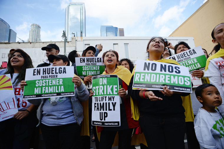 Fast food workers, healthcare workers and their supporters shout slogans at a rally and march to demand an increase of the minimum wage in Los Angeles, Calif. on Dec. 4, 2014. (Photo by Robyn Beck/AFP/Getty)