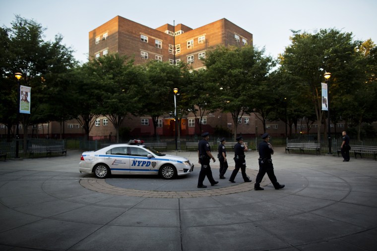 Officers walk past a parked patrol car in the Brooklyn borough of New York, N.Y. on June 24, 2014. (Photo by Victor J. Blue/The New York Times/Redux)