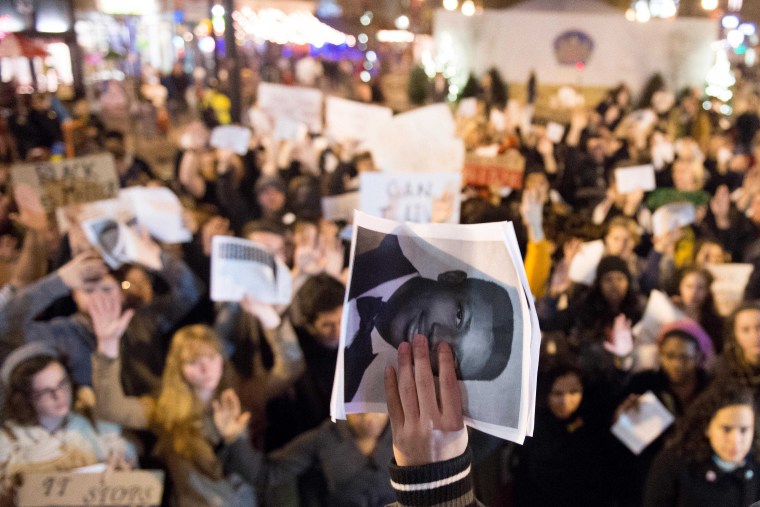 A photograph of Eric Garner is held up before a gathering of approximately 300 people in Knoxville, Tenn. for a demonstration against police brutality on Dec. 5, 2014. (Saul Young/The Knoxville News Sentinel/AP)