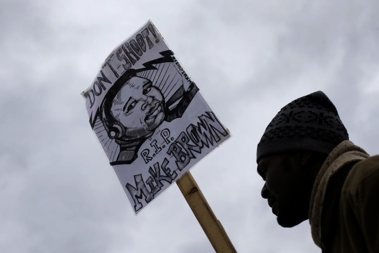 A man demonstrates against the August shooting of Michael Brown on Nov. 24, 2014, outside the police station in Ferguson, Mo. (Photo by Charlie Riedel/AP)
