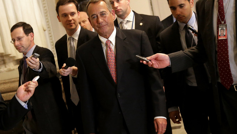 House Speaker John Boehner (C) (R-OH) walks to the House chamber for an expected vote on a $1.1 trillion government funding bill on December 11, 2014 in Washington, DC.