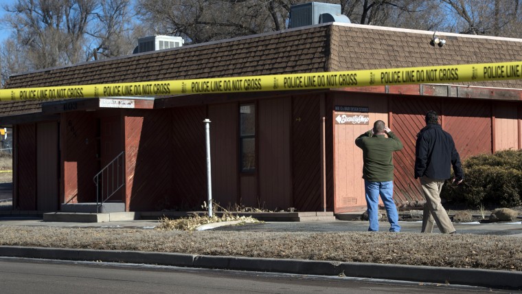 Colorado Springs police officers investigate the scene of an explosion Jan. 6, 2015, at Mr. G's Hair Salon at 603 S. El Paso Street in Colorado Springs, Colo.
