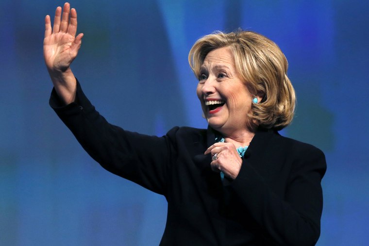 Former Secretary of State Hillary Rodham Clinton waves as she is introduced at an event in Boston, Mass., Dec. 4, 2014. (Photo by Elise Amendola/AP)