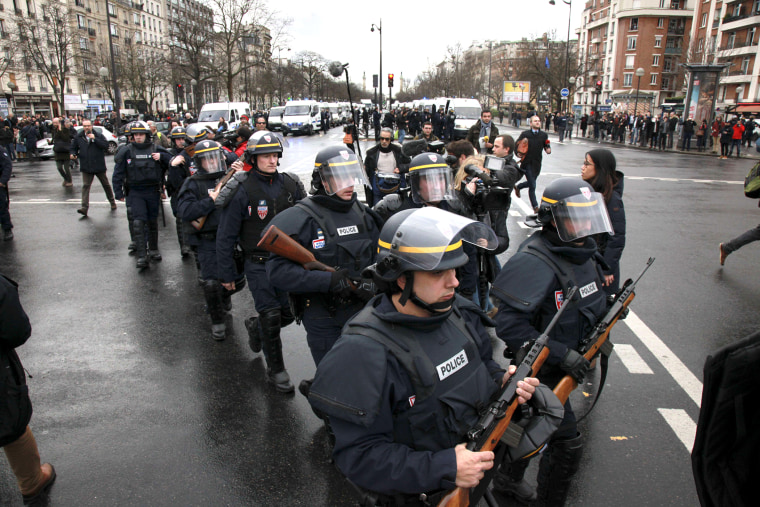 French police officers arrive to take up positions near Porte de Vincennes in Paris on Jan. 9, 2015.