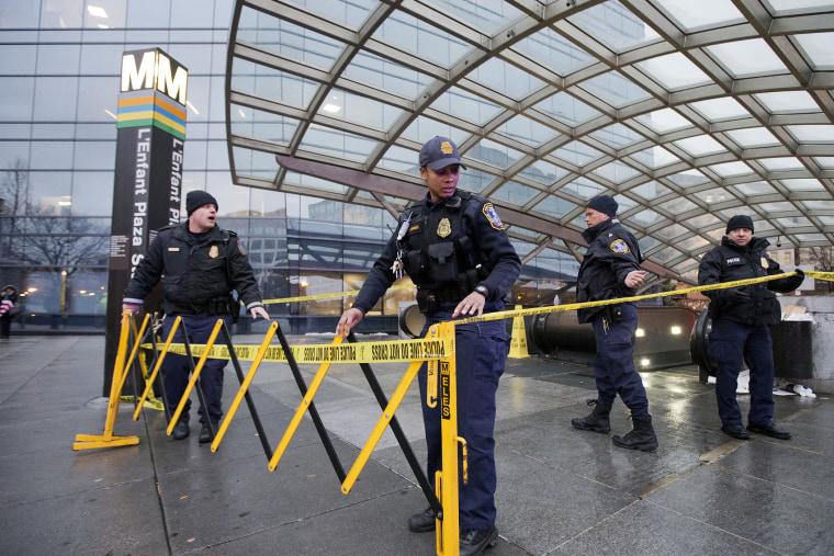 Metro Transit Police officers, secure the entrance to L'­Enfant Plaza Station in Washington, D.C., Jan. 12, 2015. (Photo by Manuel Balce Ceneta/AP)