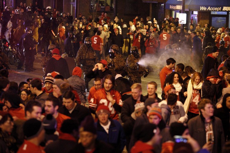 Police officers try to disperse the crowd of Ohio State fans blocking High Street in Columbus, Ohio, as they celebrate the Buckeye's 42-20 National Championship football game win over Oregon outside of campus on Jan. 12, 2015.