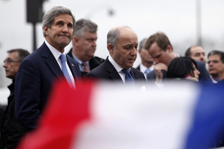 U.S. Secretary of State John Kerry, left, and French Foreign Minister Laurent Fabius visit a kosher market where four hostages were killed in a terrorist attack last Friday in Paris, on Jan. 16, 2015.