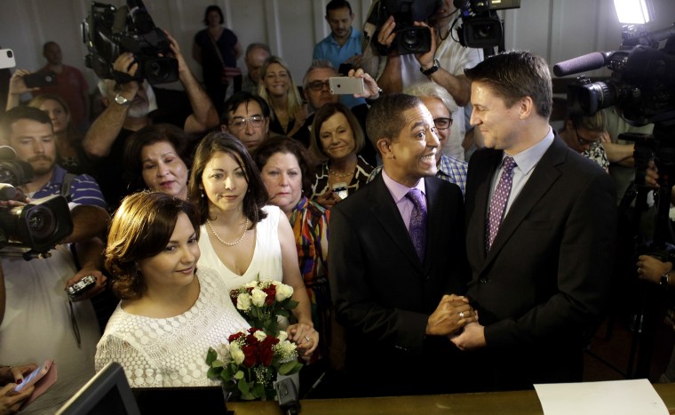 Same-sex couples Todd (2nd R), and Jeff Delmay with Catherina Pareto and Karla Arguello (L) get married at the Eleventh Judicial Circuit Court of Florida in Miami, Florida, Jan. 5, 2015. (Photo by Javier Galeano/Reuters)