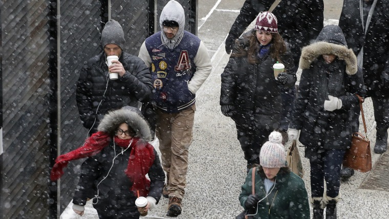 A light snow falls on pedestrians on Jan. 26, 2015 in New York.