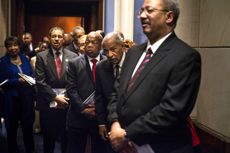Rep. Charles Rangel (D-NY) and Rep. John Lewis (D-GA) along with other members of the Congressional Black Caucus line up before the swearing-in ceremony at the U.S. Capitol on Jan. 6, 2015 in Washington, D.C.