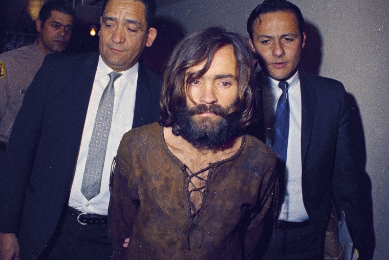 Charles Manson is escorted to his arraignment on conspiracy-murder charges in connection with the Sharon Tate murder case in 1969 in Los Angeles, Calif.
