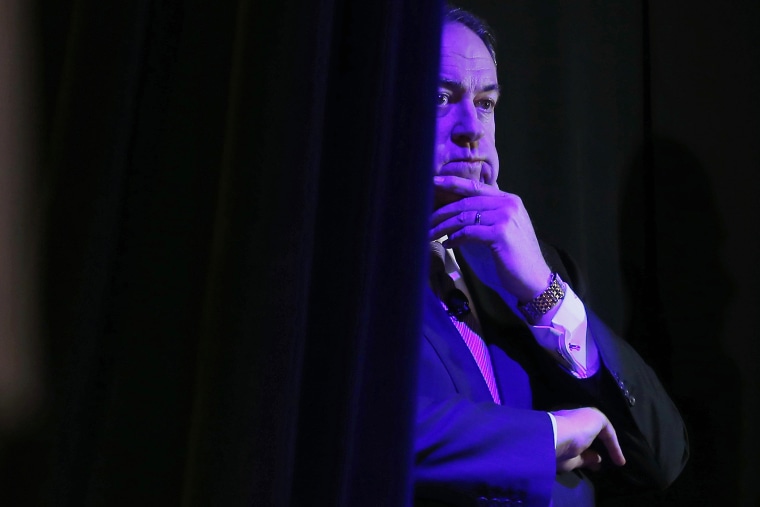 Former Governor of Arkansas Mike Huckabee listens to his introduction from the side of the stage at the Freedom Summit in Des Moines, Iowa, Jan. 24, 2015 (Photo by jim Young/Reuters)