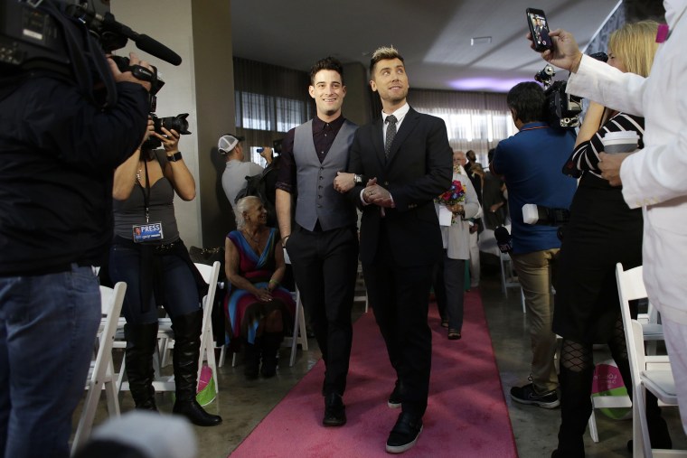 Michael Turchin, left, and Lance Bass,right, arrive for a group wedding ceremony at a hotel in honor of Florida's ruling in favor of same-sex marriage equality, Feb. 5, 2015, in Fort Lauderdale, Fla. (Photo by Lynne Sladky/AP)