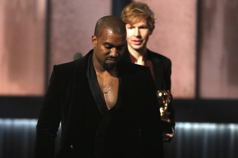 Beck watches Kanye West, who pretended to take the stage after Beck won album of the year for \"Morning Phase,\" at the 57th annual Grammy Awards in Los Angeles, Calif., on Feb. 8, 2015. (Photo by Lucy Nicholson/Reuters)