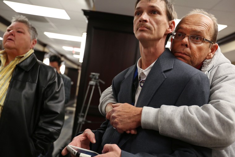 John Humphrey, left, and James Strawser wait for a marriage license along with several other gay couples at the Mobile County Probate office in Mobile, Ala., on Feb. 10, 2015. (Photo by Sharon Steinmann/AL.com/AP)