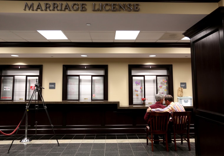 Milton Persinger, left, and Robert Povilat wait for a marriage license at the Mobile County Probate office, Feb. 10, 2015, in Mobile, Ala. (Photo by Sharon Steinmann/AP)