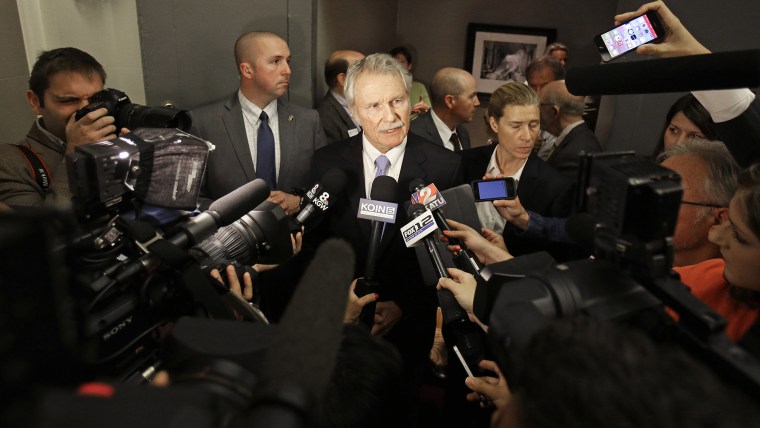 Oregon Democratic Gov. John Kitzhaber is surrounded by cameras and reporters as he makes a statement in Portland, Ore., Oct. 10, 2014. (Photo by Don Ryan/AP)