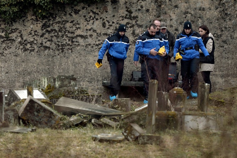 French Gendarmes investigate near defaced tombstones at the Jewish cemetery of Sarre-Union, northeastern France on Feb. 16, 2015. (Photo by Frederick Florin/AFP/Getty)