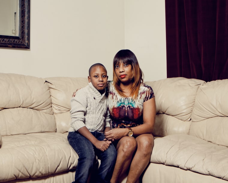 Constance Malcolm at home with her son. The 9-year-old boy witnessed his brother's death three years ago.