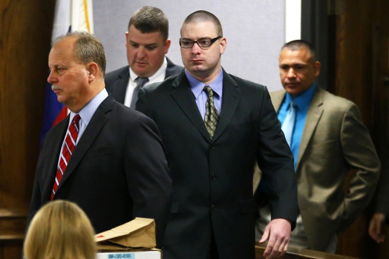 Former Marine Cpl. Eddie Ray Routh, center, is led into court by his defense attorney at the Erath County Donald R. Jones Justice Center in Stephenville, Texas, Feb. 12, 2015. (Photo by Tom Fox/The Dallas Morning News/Pool/AP)